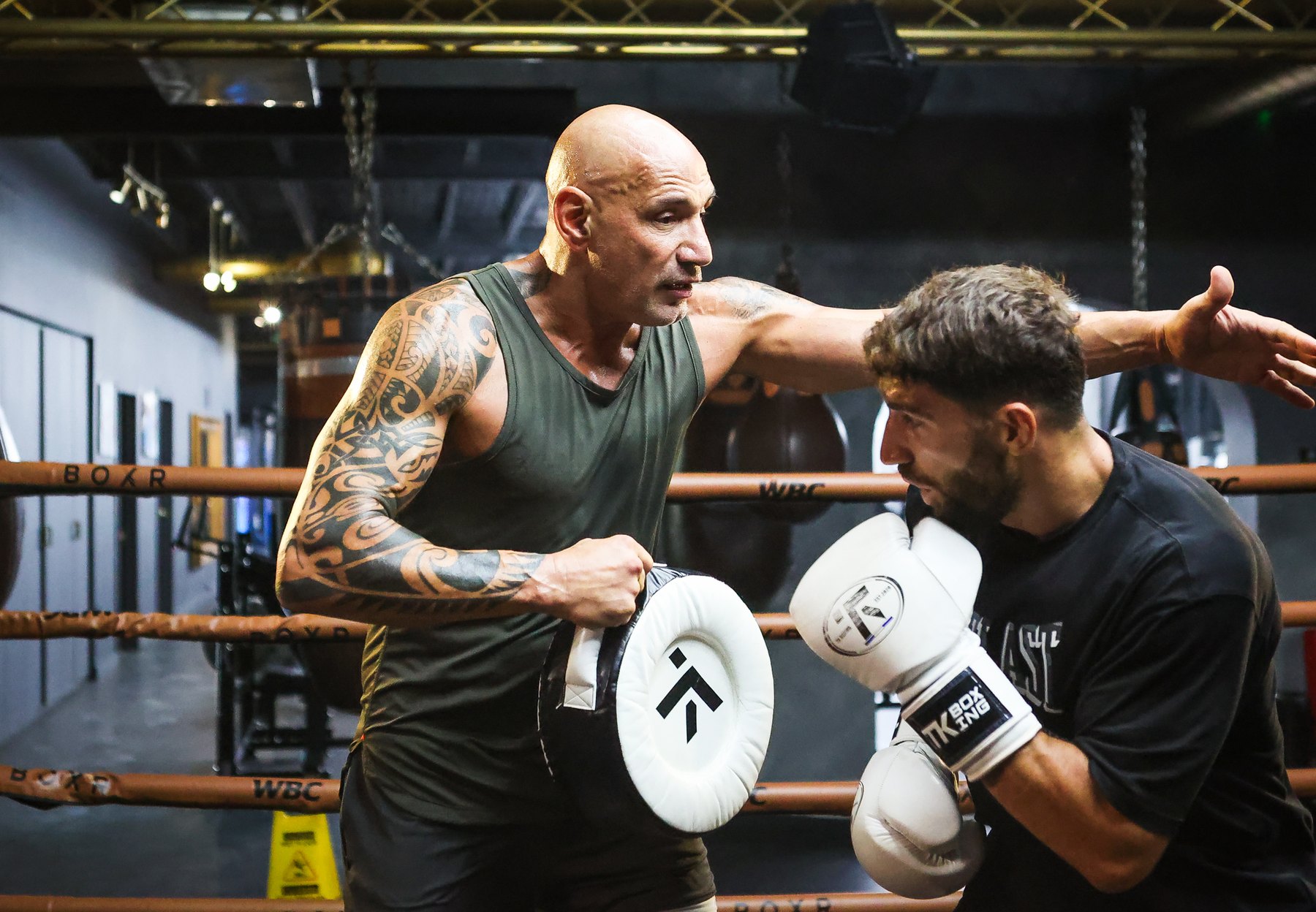 Pad round with a client at the gym